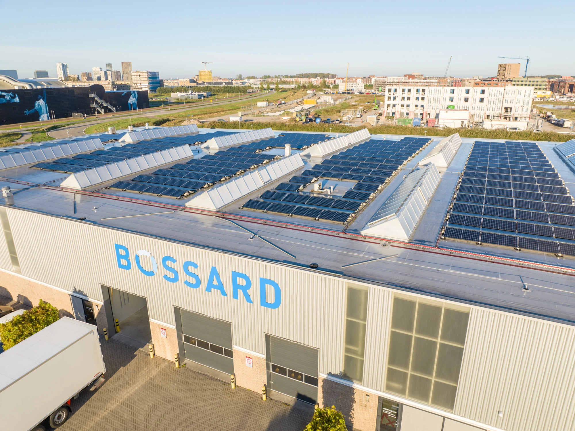 Aerial view of the Bossard business unit in the Netherlands, showcasing the building with solar panels and the surrounding outdoor areas.
