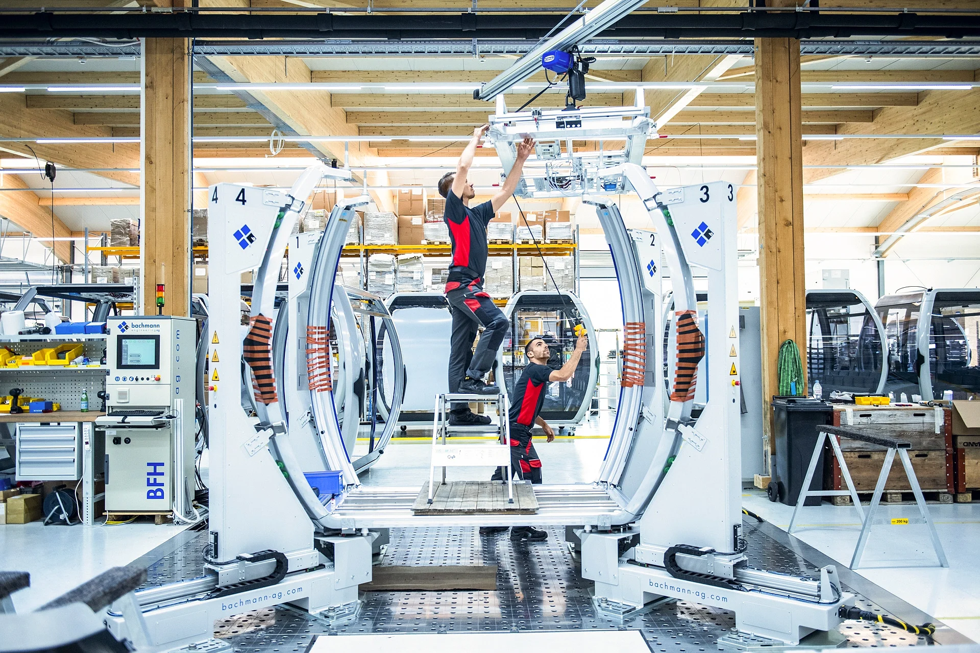Technicians working on a CWA cabin in a modern manufacturing facility
