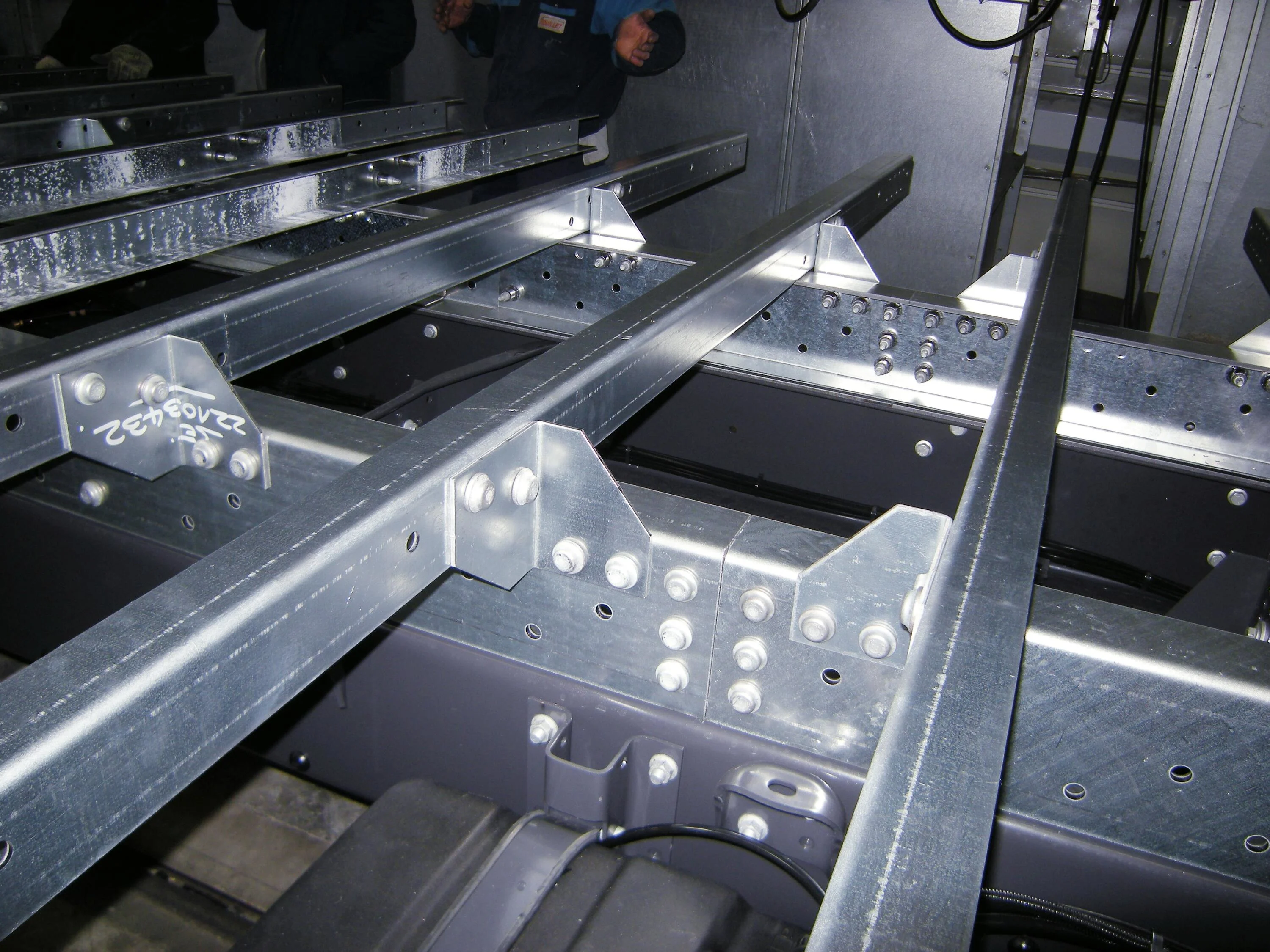 Steel structure featuring Huck BobTail® rivets, showcasing a robust design with visible rivet connections.
